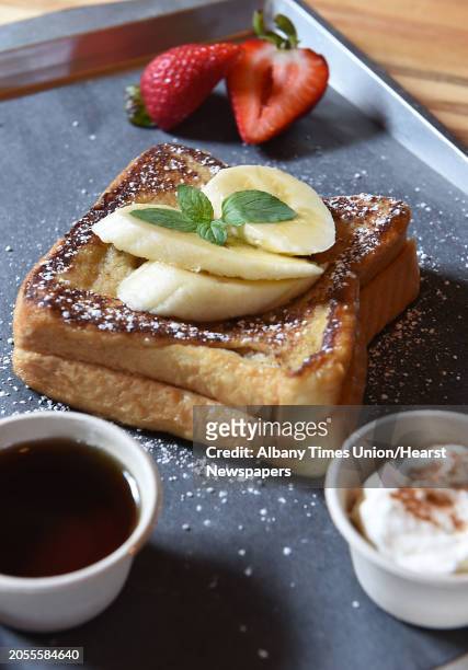 Banana stuffed French toast with Vermont maple syrup and cinnamon whipped cream at Farmers Hardware restaurant on Wednesday, July 26, 2017 in...