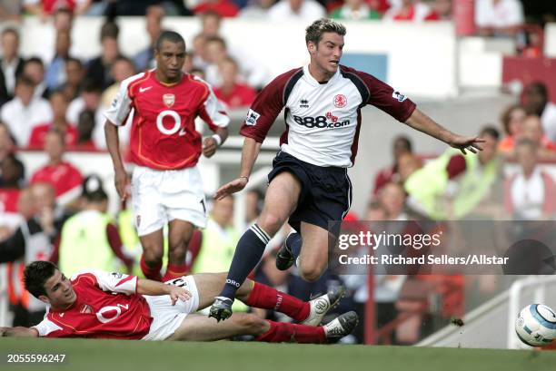 August 22: Franck Queudrue of Middlesbrough and Cesc Fabregas challenge during the Premier League match between Arsenal and Middlesbrough at Highbury...