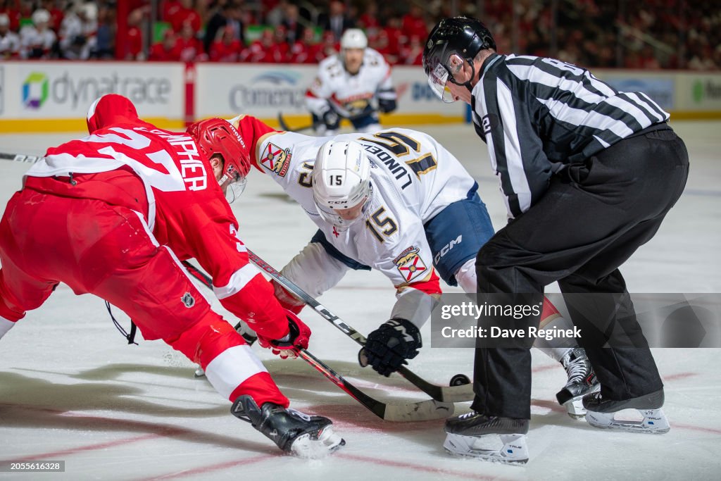 Ryan Compher Linesman Ryan Galloway drops the puck between J.T. Compher of the ...