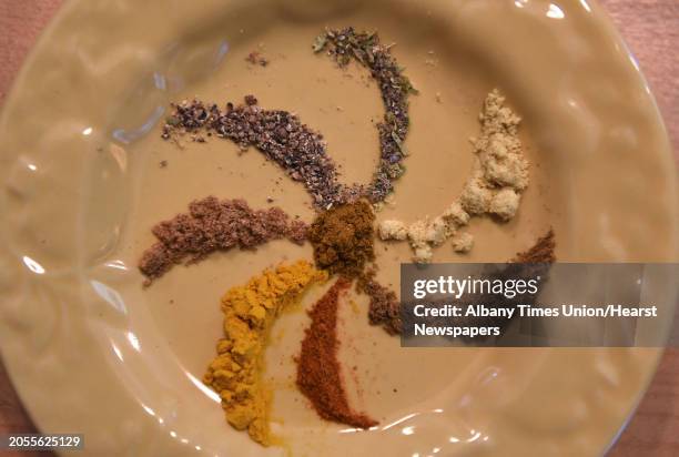 The spice curry powder in center is made up of, from left, coriander, black pepper, cardamom, mustard, cumin, cayenne pepper and turmeric at Caroline...