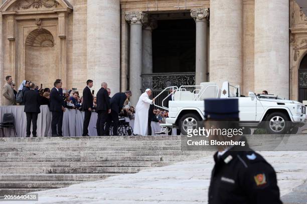 Pope Francis attempts to board his popemobile as he departs following his weekly audience in St. Peter's Square at the Vatican, on Wednesday, March...