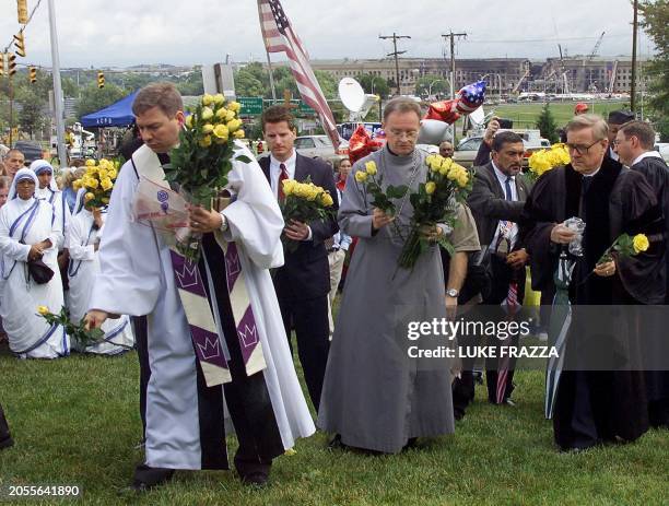 Clergy and lay people participante in a prayer service for the victims in front of the damaged side of the Pentagon in Washington, DC 14 September,...