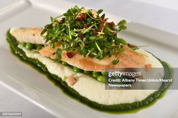 Branzino with enlish peas, cauliflower puree, crispy prosciutto, toasted almond, brown butter, truffled pea tendrils and basil puree at Ronnie &...