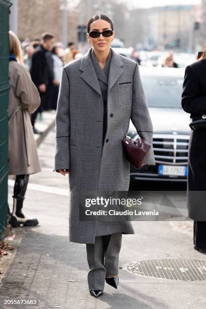 Tamara Kalinic wears grey checed suit, matching grey checked coat, black heels, burgundy bag, outside Ferragamo, during the Milan Fashion Week -...