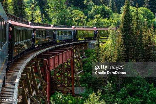 white pass summit excursion tour train in the mountains, alaska, usa. - skagway alaska stock pictures, royalty-free photos & images