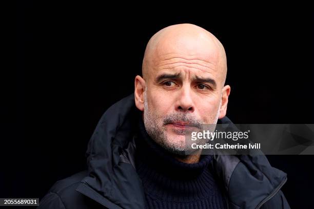 Pep Guardiola, Manager of Manchester City, looks on prior to the Premier League match between Manchester City and Manchester United at Etihad Stadium...