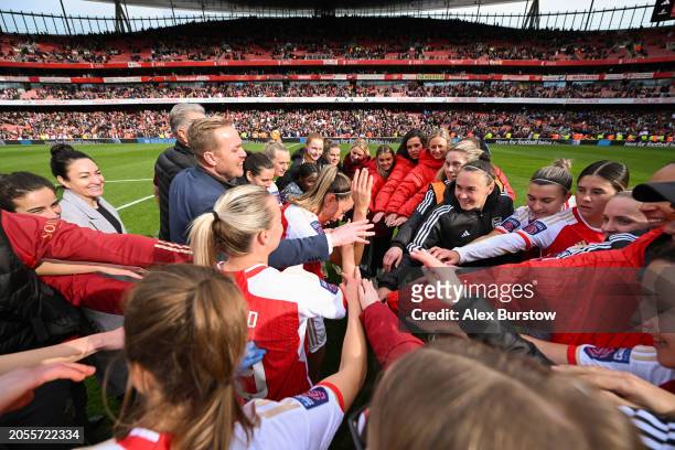 The Arsenal team form a huddle on the pitch as they celebrate their victory after the Barclays Women's Super League match between Arsenal FC and...