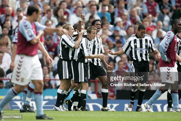 August 28: Craig Bellamy, Lee Bowyer, Patrick Kluivert and Jermaine Jenas of Newcastle United celebrates during the Premier League match between...