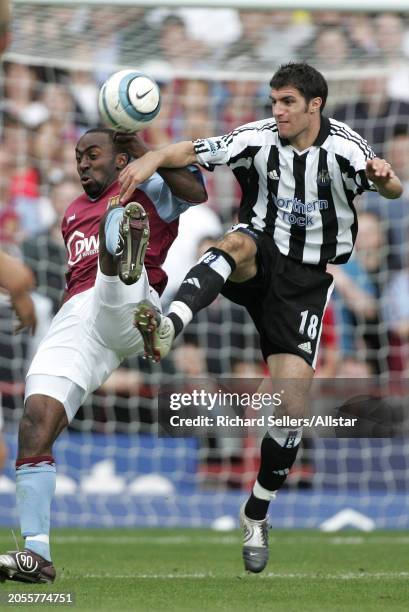 August 28: Darius Vassell of Aston Villa and Aaron Hughes of Newcastle United challenge during the Premier League match between Aston Villa and...