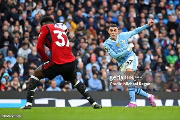 Kobbie Mainoo of Manchester United blocks the shot of Phil Foden of Manchester City during the Premier League match between Manchester City and...