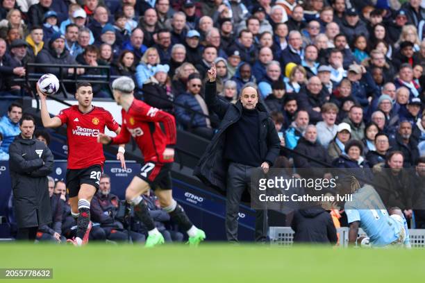 Pep Guardiola, Manager of Manchester City, gives the team instructions during the Premier League match between Manchester City and Manchester United...