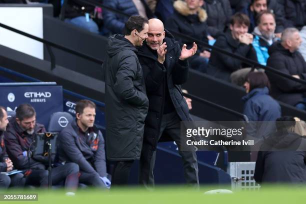 Pep Guardiola, Manager of Manchester City, interacts with Fourth Official Darren England during the Premier League match between Manchester City and...