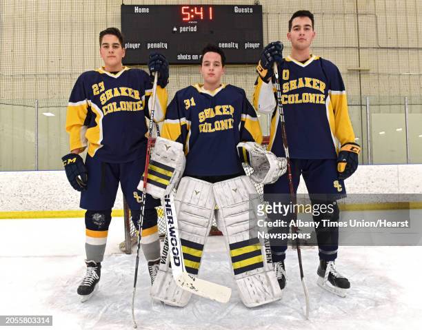 Shaker/Colonie senior hockey triplets, from left, Mike, Dan and Joe Molloy stand in front of the net at the Albany County Hockey Rink on Thursday,...