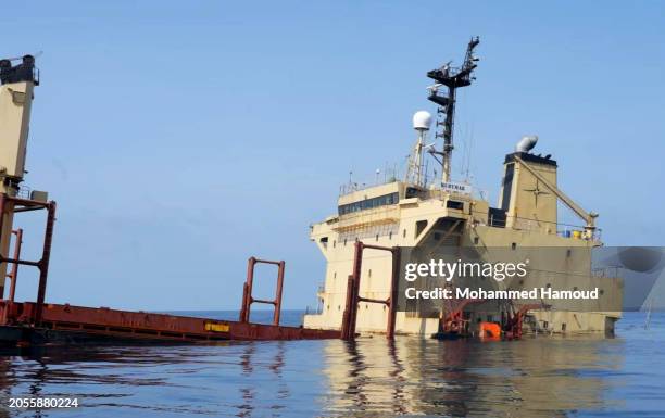 This handout photo provided by Yemeni Al-Joumhouria TV, shows the British-registered cargo ship 'Rubymar' sinking, after it was targeted by Yemen's...