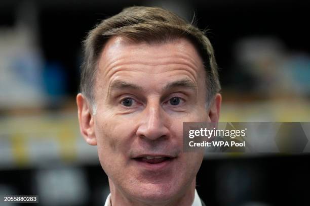 Chancellor Jeremy Hunt speaks to a Tv reporter during a visit to a builders warehouse on March 6, 2024 in London, England.