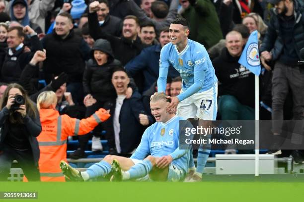 Erling Haaland of Manchester City celebrates with Phil Foden of Manchester City after scoring his team's third goal during the Premier League match...