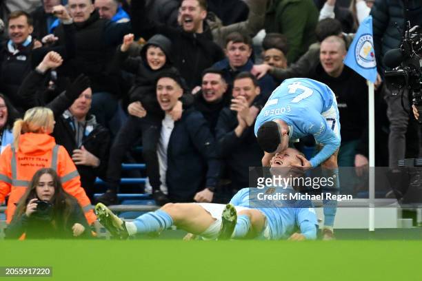 Erling Haaland of Manchester City celebrates with Phil Foden of Manchester City after scoring his team's third goal during the Premier League match...