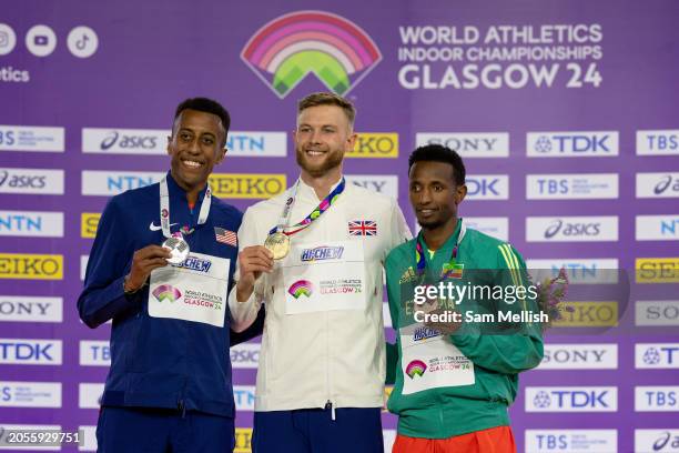 Yared Nuguse of the United States, Josh Kerr of Great Britain and Selemon Barega of Ethiopia pose for photos during the medal ceremony for the Mens...