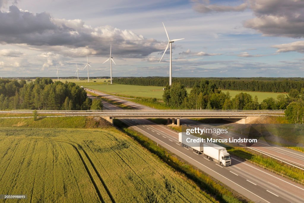 Highway transport in a rural landscape with wind power stations