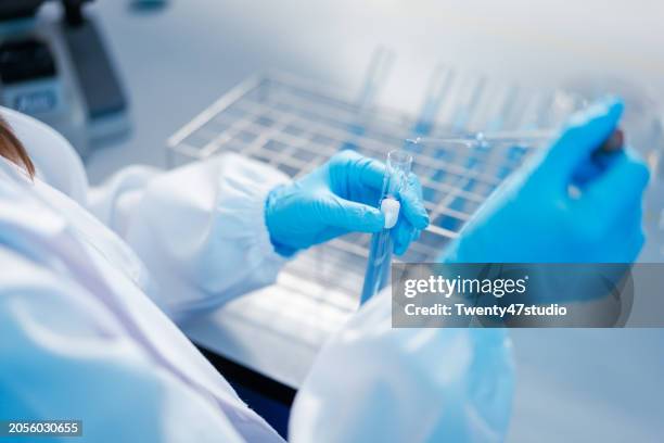 young asian scientist working in the laboratory - scientific research stock pictures, royalty-free photos & images
