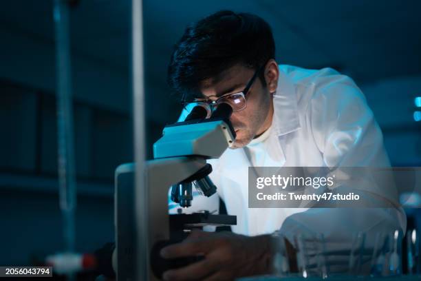 young caucasian scientist working in the laboratory - mikroskop stock-fotos und bilder