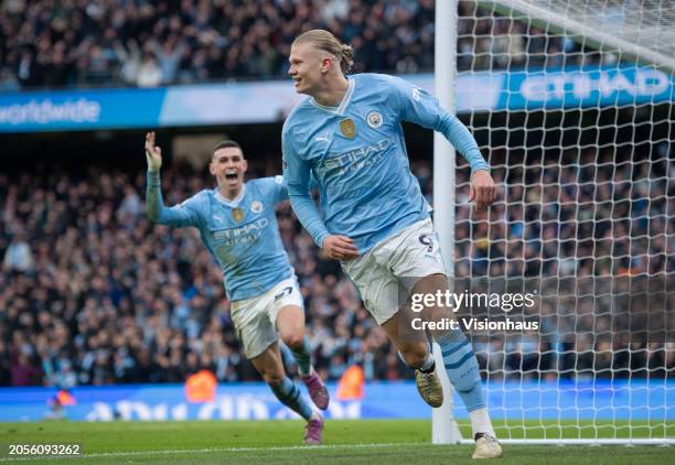 Erling Haaland of Manchester City celebrates scoring his team's third goal with team mate Phil Foden during the Premier League match between...