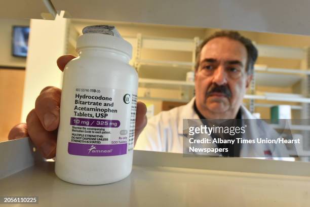Pharmacist Augustine Barranca reaches for a bottle of Hydrocodone at the pharmacy the Capital South Campus Center on Wednesday, July 25, 2018 in...