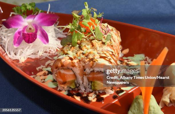 French cake, spicy salmon, avocado, topped with tobiko, yellowtail, salmon, tempura flakes, teriyaki sauce, spicy sauce and house special sauce at...