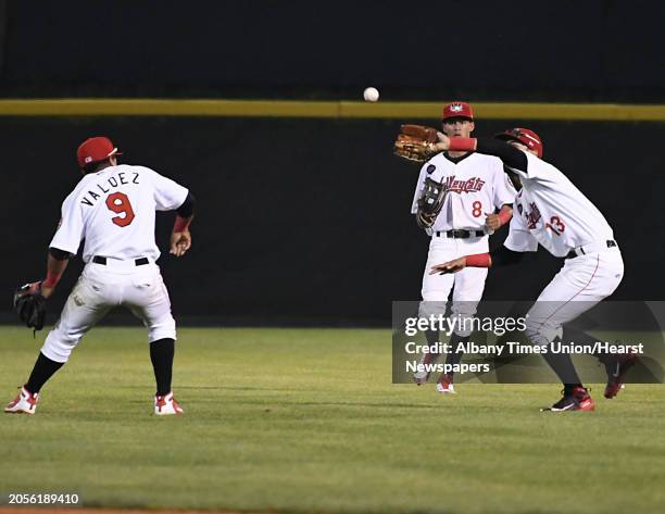 Tri-City ValleyCats' Carlos Machado, right, calls off Enmanuel Valdez, left, and Ramiro Rodriguez to catch a fly ball into right field during a...