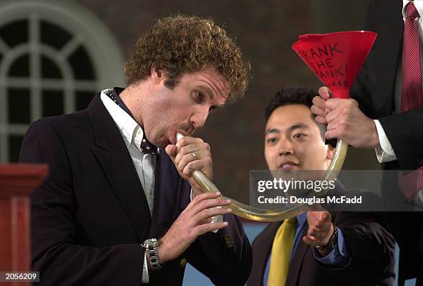 Actor Will Ferrell, of Saturday Night Live and the recent movie "Old School", gives graduating Harvard students a laugh as he funnels a beer during...