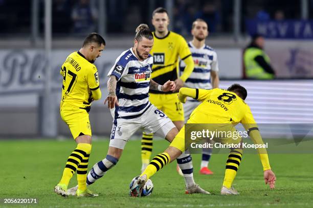 Lion Semic of Dortmund and Franz Roggow of Dortmund challenge Daniel Ginczek of Duisburg during the 3. Liga match between MSV Duisburg and Borussia...