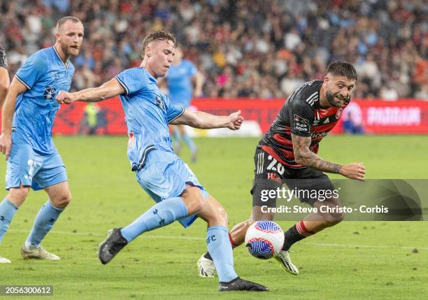 Brandon Borrello of the Wanderers and Sydney FC's Jake Girdwood-Reich challenge for there ball during the A-League Men round 19 match between Western...