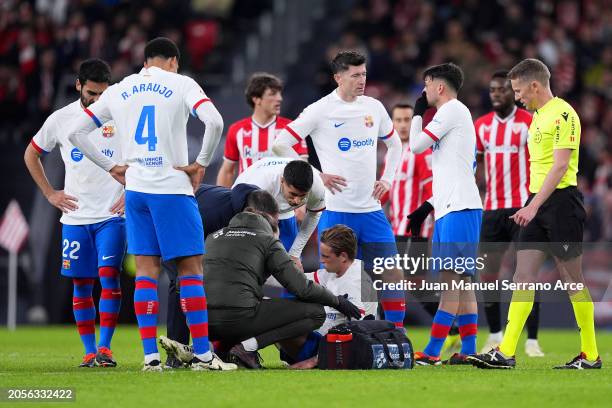 Frenkie de Jong of FC Barcelona receives medical treatment after picking up an injury during the LaLiga EA Sports match between Athletic Bilbao and...