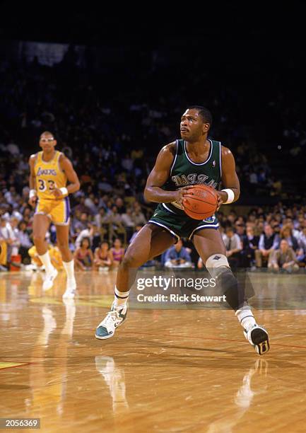 Mark Aguirre of the Dallas Mavericks moves the ball during the NBA game against the Los Angeles Lakers at the Great Western Forum in Los Angeles,...