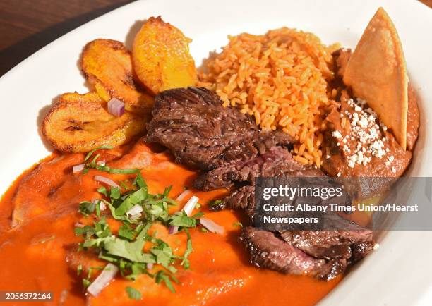 Tampiquena- hanger steak with two roja cheese enchiladas, plantains and a side of rice and refried pinto beans at Pico de Gallo restaurant on...