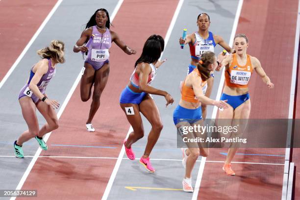 Ama Pipi of Team Great Britain, Bailey Lear of Team United States and Lisanne De Witte of Team Netherlands pass their batons in the Women's 4x400...