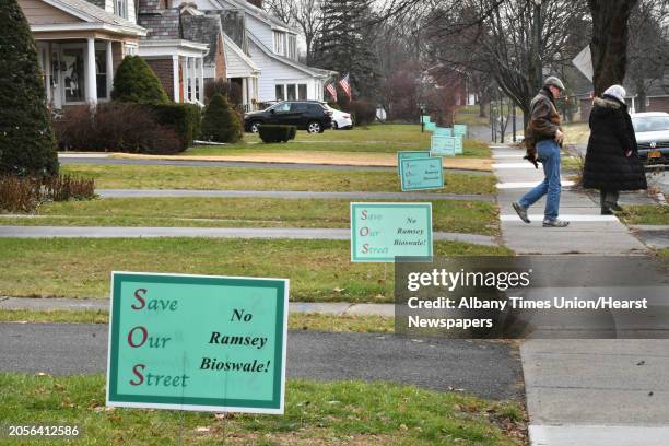"Save Our Street, No Ramsey Bioswale!" signs are seen in front of homes along Ramsey Place on Wednesday, Dec. 5, 2018 in Albany, N.Y.