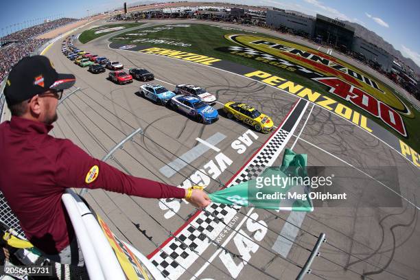 Joey Logano, driver of the Pennzoil Ford, leads the field to the green flag to start the NASCAR Cup Series Pennzoil 400 at Las Vegas Motor Speedway...