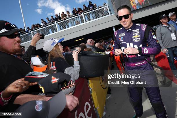 Alex Bowman, driver of the Ally Chevrolet, signs autographs for NASCAR fans prior to the NASCAR Cup Series Pennzoil 400 at Las Vegas Motor Speedway...