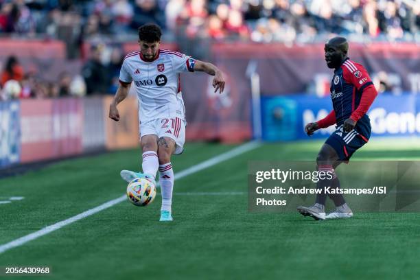 Jonathan Osorio of Toronto FC passes the ball as Emmanuel Boateng of New England Revolution closes during a game between Toronto FC and New England...