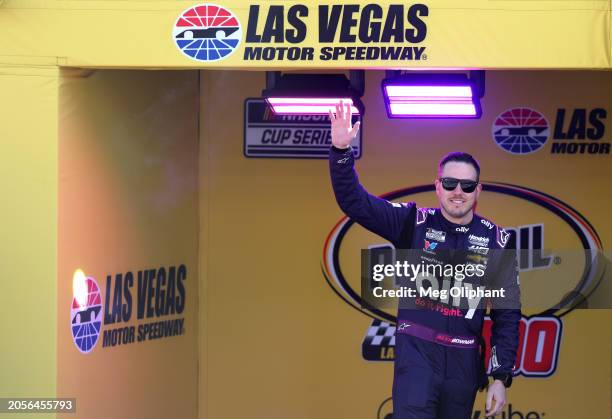 Alex Bowman, driver of the Ally Chevrolet, waves to fans as he walks onstage during driver intros prior to the NASCAR Cup Series Pennzoil 400 at Las...