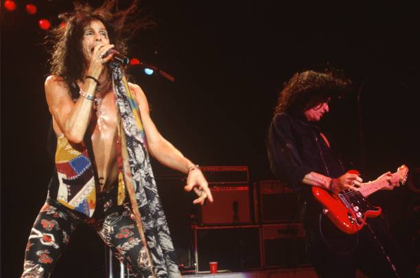 Steven Tyler and Joe Perry of Aerosmith perform at Shoreline Amphitheatre on October 8, 1994 in Mountain View, California.