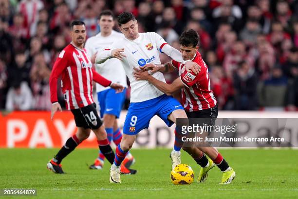 Robert Lewandowski of FC Barcelona is challenged by Benat Prados of Athletic Club during the LaLiga EA Sports match between Athletic Bilbao and FC...