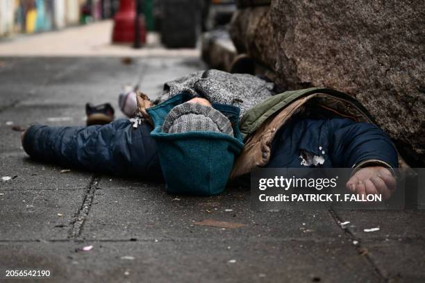 Person lays on the street in the Old Town Chinatown neighborhood following the decriminalization of all drugs including fentanyl and meth in downtown...