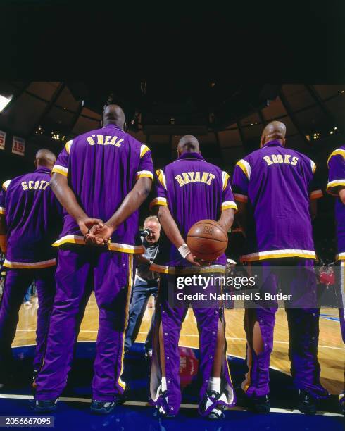 Shaquille O'Neal, Kobe Bryant and Sean Rooks of the Los Angeles Lakers stands for the National Anthem against the New York Knicks at Madison Square...