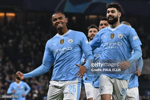 Manchester City's Swiss defender Manuel Akanji celebrates with teammates after scoring the opening goal of the UEFA Champions League round of 16,...