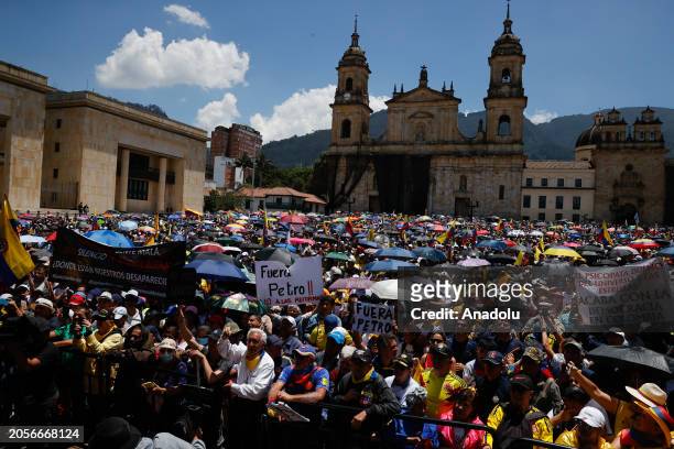 People gather at the Bolivar Square as the former members of the Colombian Military Forces march to protest against Colombian President Gustavo Petro...