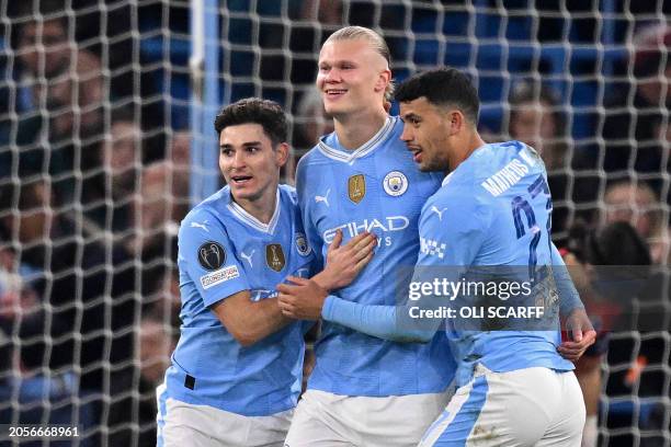 Manchester City's Norwegian striker Erling Haaland celebrates with Manchester City's Argentinian striker Julian Alvarez and Manchester City's...