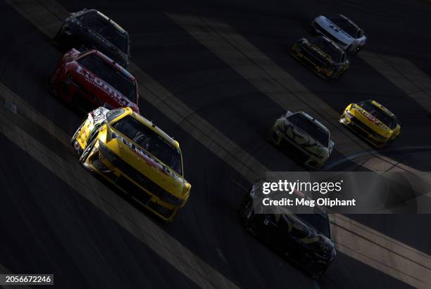 Ryan Blaney, driver of the Menards/Pennzoil Ford, and Austin Dillon, driver of the BetMGM Chevrolet, race during the NASCAR Cup Series Pennzoil 400...