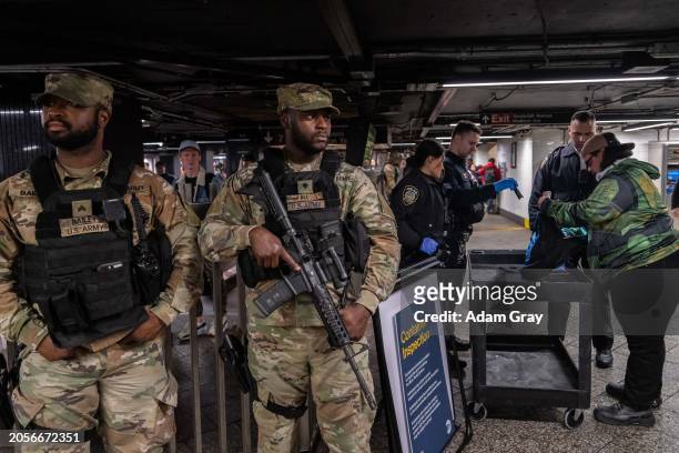 New York State Police, MTAPD and New York National Guard patrol and conduct container inspections at Grand Central Station on March 6, 2024 in New...